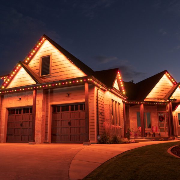 Modern house with orange permanent LED lighting accenting the roofline at night